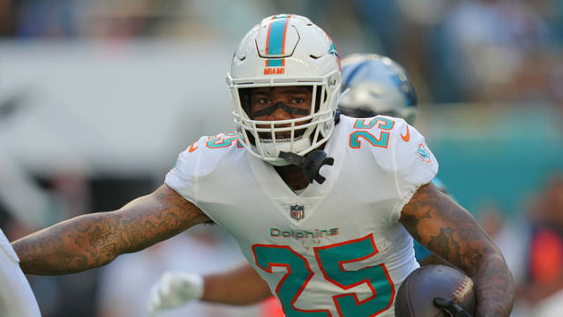 Dolphins cornerback Xavien Howard (25) runs with the ball after intercepting a pass from Panthers quarterback Cam Newton.